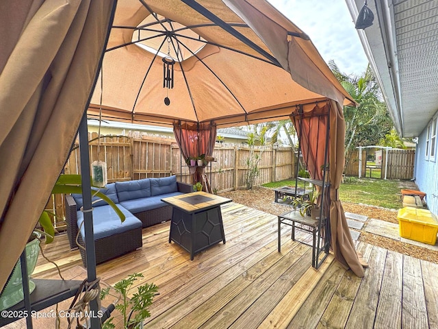 wooden terrace with a gazebo and an outdoor living space with a fire pit