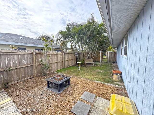 view of yard with an outdoor fire pit