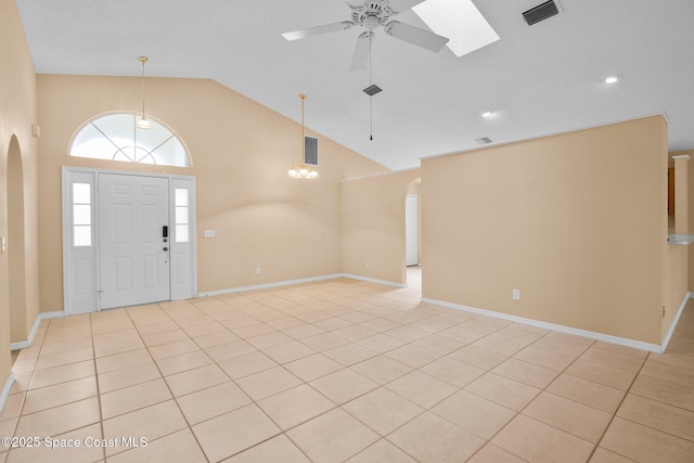 foyer entrance featuring high vaulted ceiling, light tile patterned floors, and ceiling fan