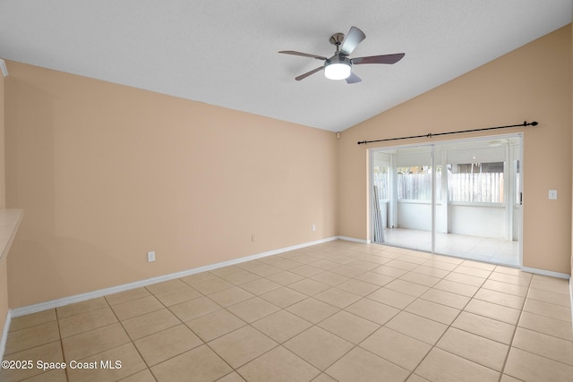 tiled empty room featuring vaulted ceiling, a textured ceiling, and ceiling fan