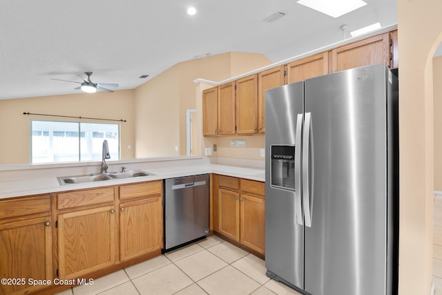 kitchen with lofted ceiling, sink, light tile patterned floors, ceiling fan, and appliances with stainless steel finishes