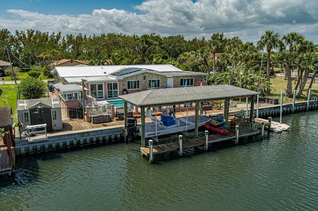 view of dock with a pool and a water view