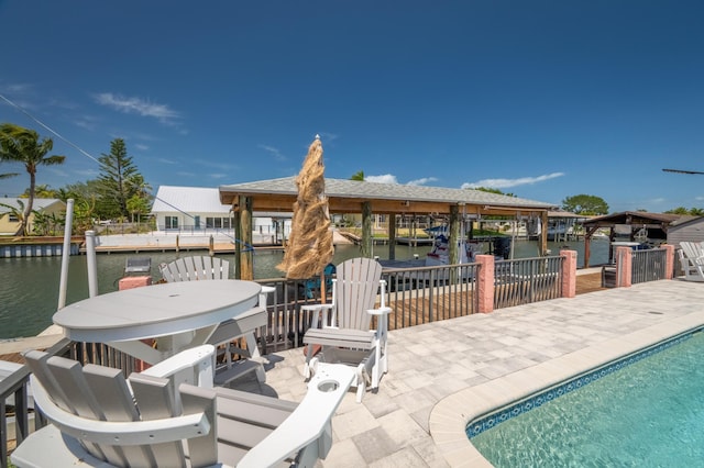 view of patio / terrace with a boat dock and a water view