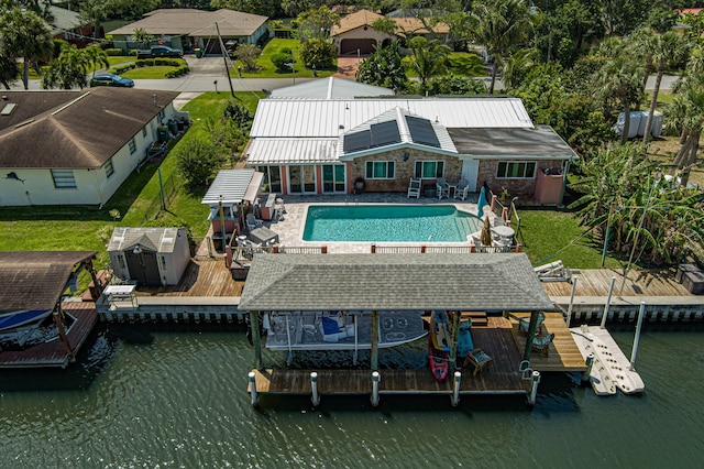 exterior space featuring a shed, a patio, and a water view