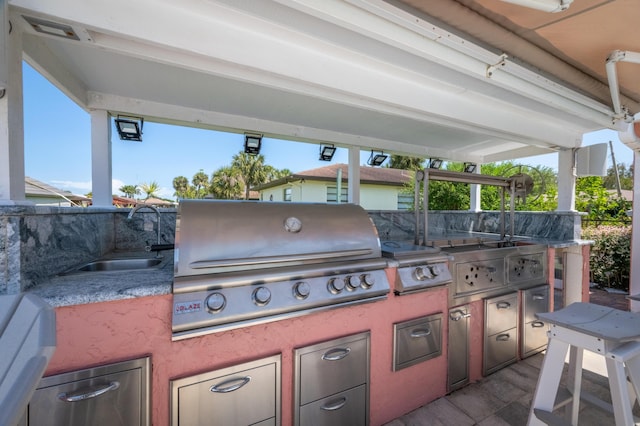 view of patio / terrace featuring a grill, sink, and exterior kitchen