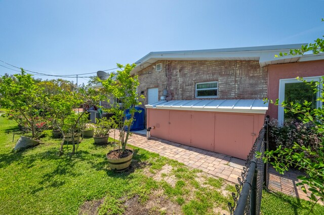 view of side of home with a yard