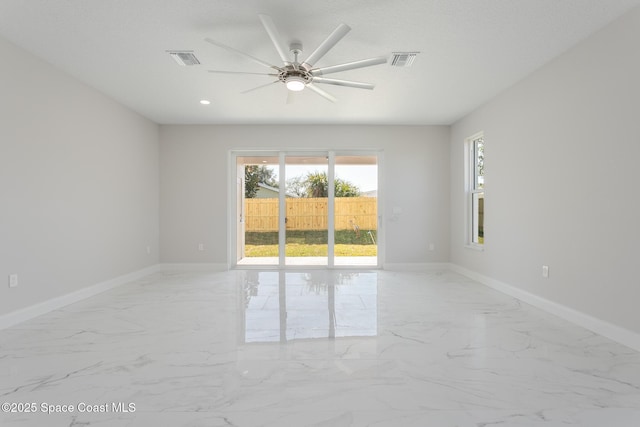 spare room with ceiling fan and a textured ceiling