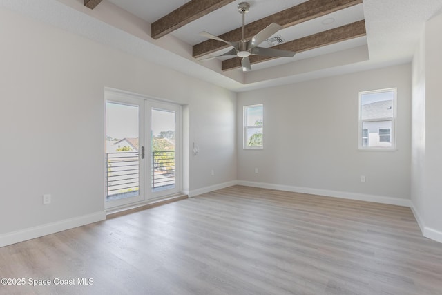 unfurnished room featuring ceiling fan, light hardwood / wood-style flooring, french doors, and beamed ceiling