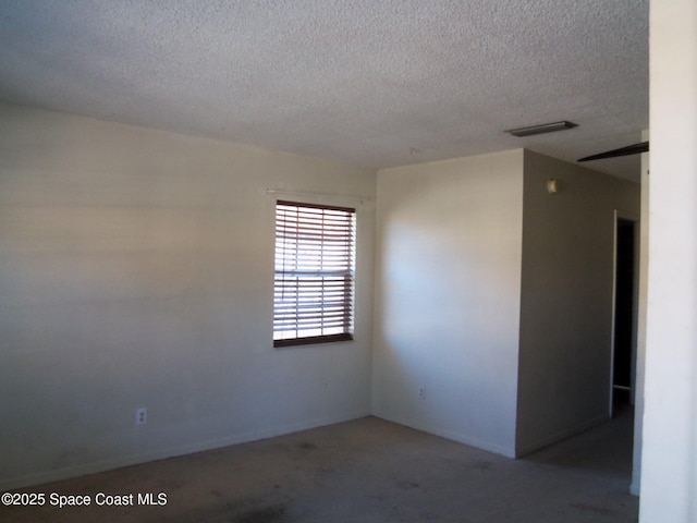 spare room with a textured ceiling