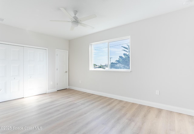 unfurnished bedroom featuring a closet, ceiling fan, and light hardwood / wood-style flooring