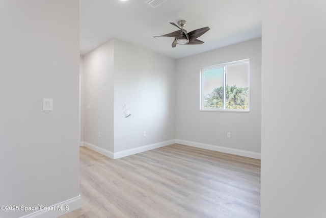 empty room with ceiling fan and light hardwood / wood-style floors