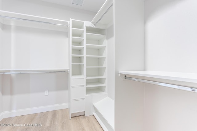 spacious closet featuring light hardwood / wood-style floors