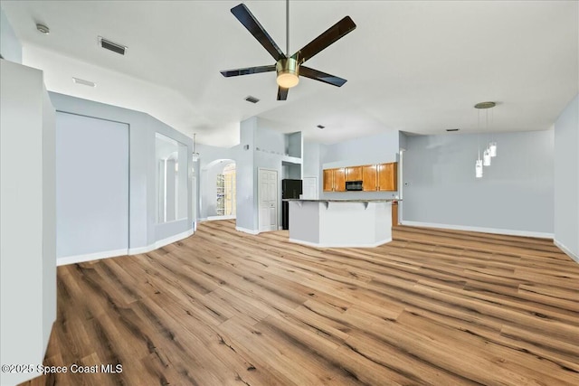 unfurnished living room featuring light hardwood / wood-style floors and ceiling fan