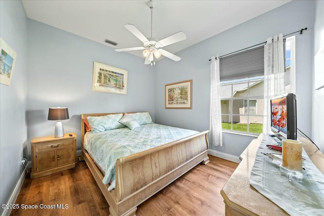 bedroom with ceiling fan and wood-type flooring