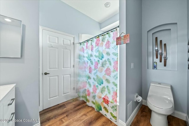 bathroom featuring hardwood / wood-style flooring, vanity, a shower with curtain, and toilet