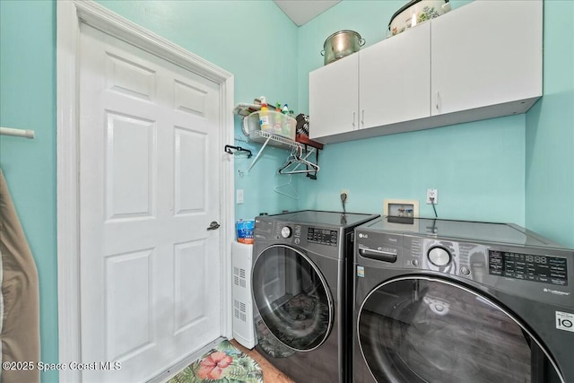 laundry area with cabinets and washing machine and clothes dryer