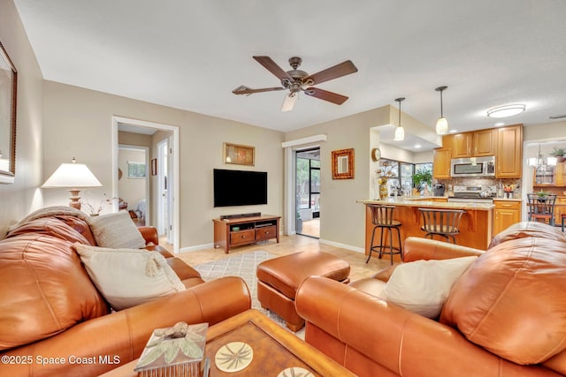 tiled living room with ceiling fan