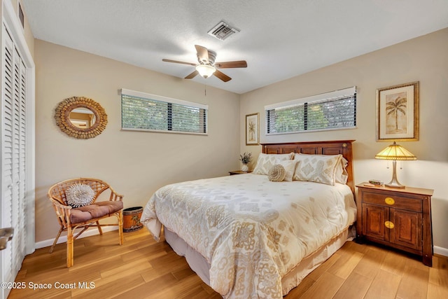 bedroom featuring a closet, ceiling fan, and light wood-type flooring