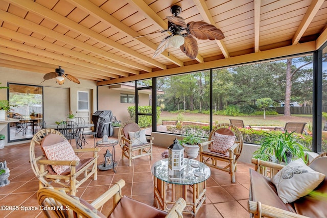 sunroom / solarium featuring ceiling fan, beam ceiling, and wooden ceiling