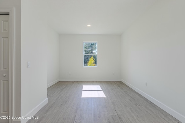 unfurnished room with light wood-type flooring