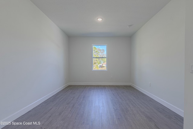 empty room with dark hardwood / wood-style floors