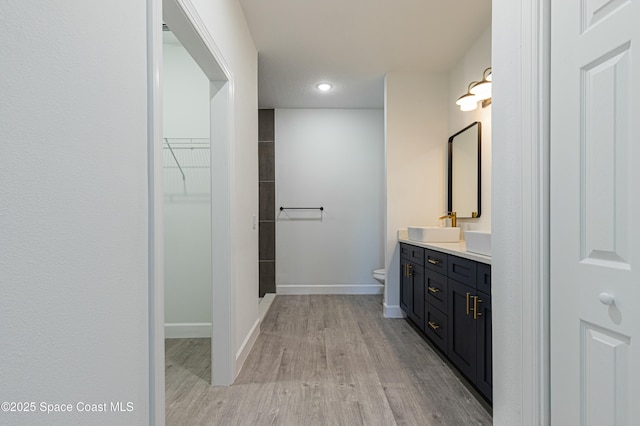 bathroom featuring vanity, toilet, and wood-type flooring