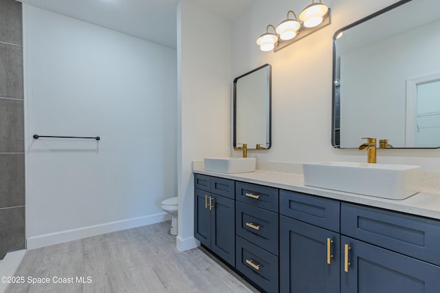 bathroom featuring hardwood / wood-style flooring, vanity, and toilet