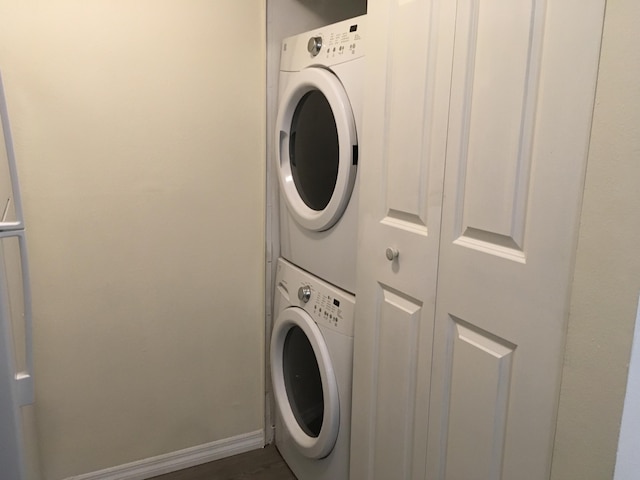 laundry room with stacked washer / dryer