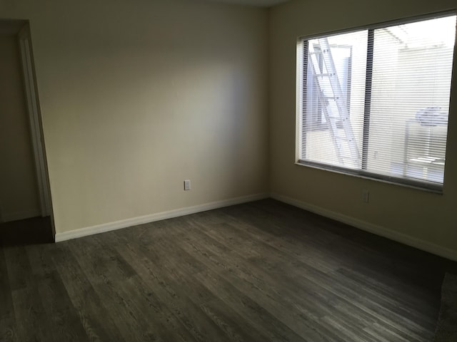 spare room with dark hardwood / wood-style flooring