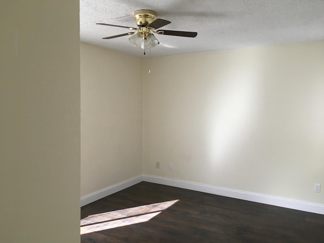 spare room featuring ceiling fan, dark hardwood / wood-style floors, and a textured ceiling