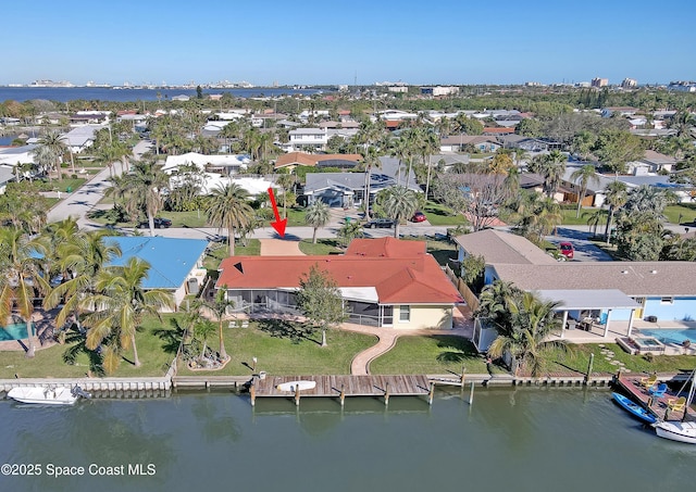 birds eye view of property with a water view