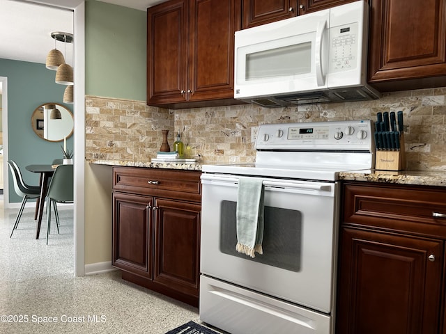 kitchen featuring pendant lighting, white appliances, light stone countertops, and decorative backsplash