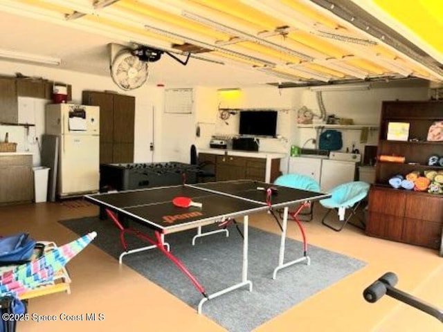 recreation room with independent washer and dryer and concrete flooring