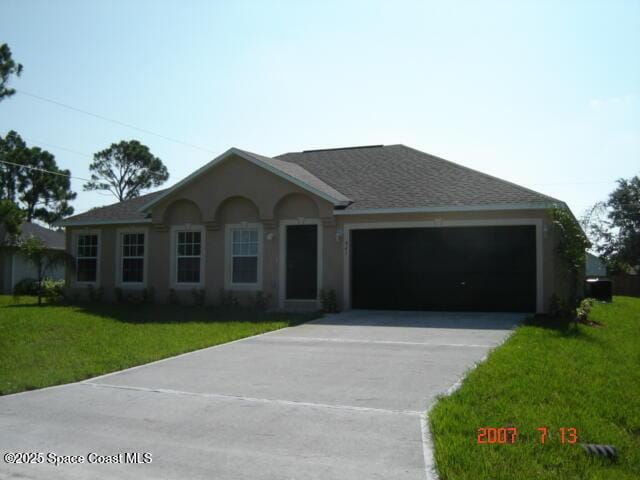 ranch-style home with a garage and a front yard