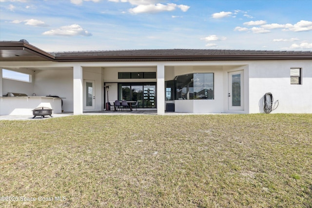 back of house with a yard and a patio area