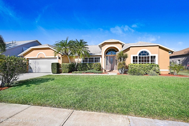 view of front of home featuring a garage and a front yard