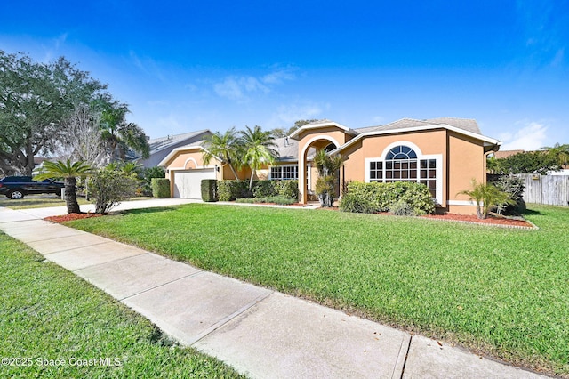 view of front of house featuring a garage and a front lawn