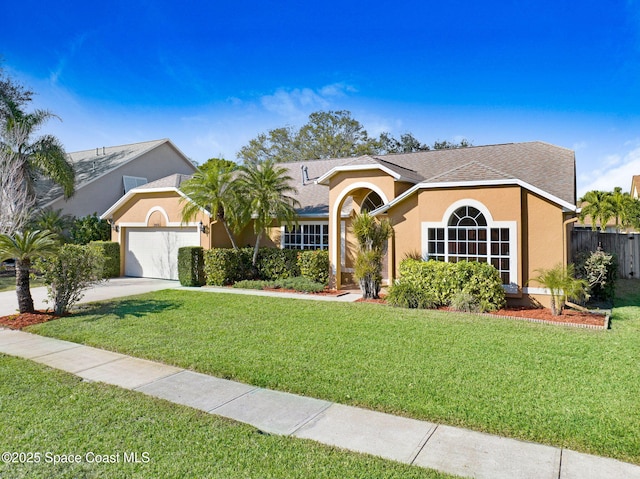 ranch-style home featuring a garage and a front lawn