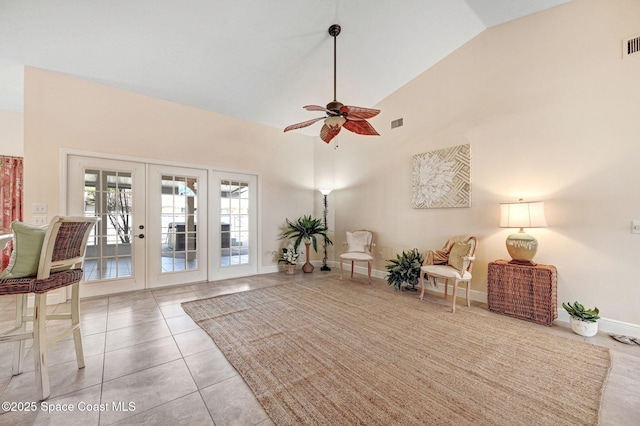 living area with light tile patterned flooring, ceiling fan, high vaulted ceiling, and french doors