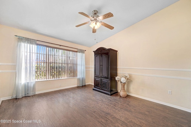 unfurnished living room with dark wood-type flooring, ceiling fan, and vaulted ceiling