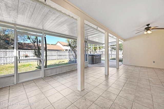 unfurnished sunroom featuring ceiling fan