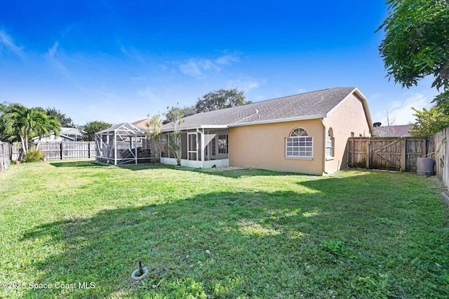 rear view of house with a yard