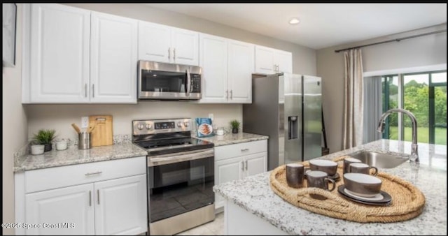 kitchen with white cabinetry and appliances with stainless steel finishes