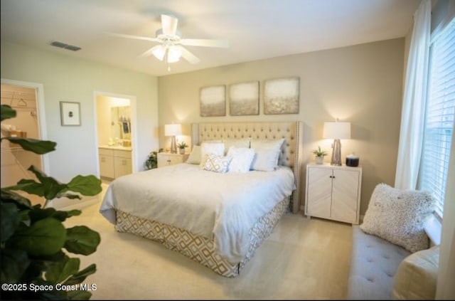 carpeted bedroom featuring ceiling fan and ensuite bathroom