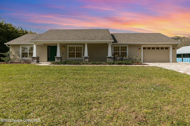 view of front facade with a garage and a lawn