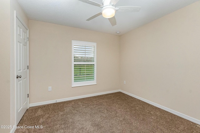 empty room with ceiling fan and carpet flooring