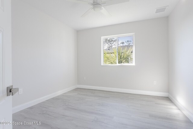 spare room with ceiling fan and light wood-type flooring