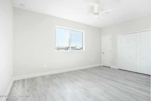 unfurnished bedroom featuring ceiling fan, light hardwood / wood-style floors, and a closet