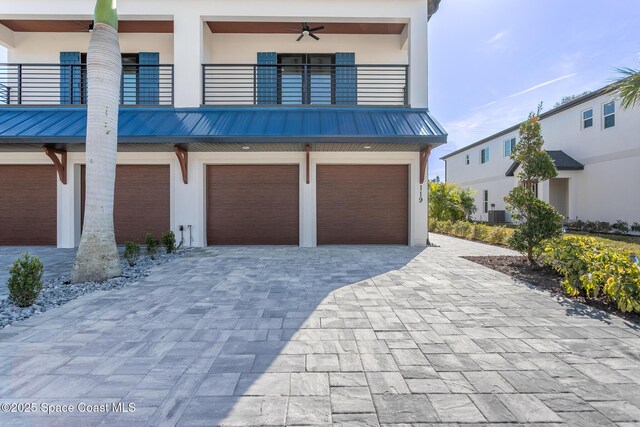 view of front of house featuring a garage and a balcony