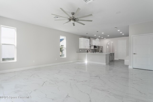 unfurnished living room featuring ceiling fan